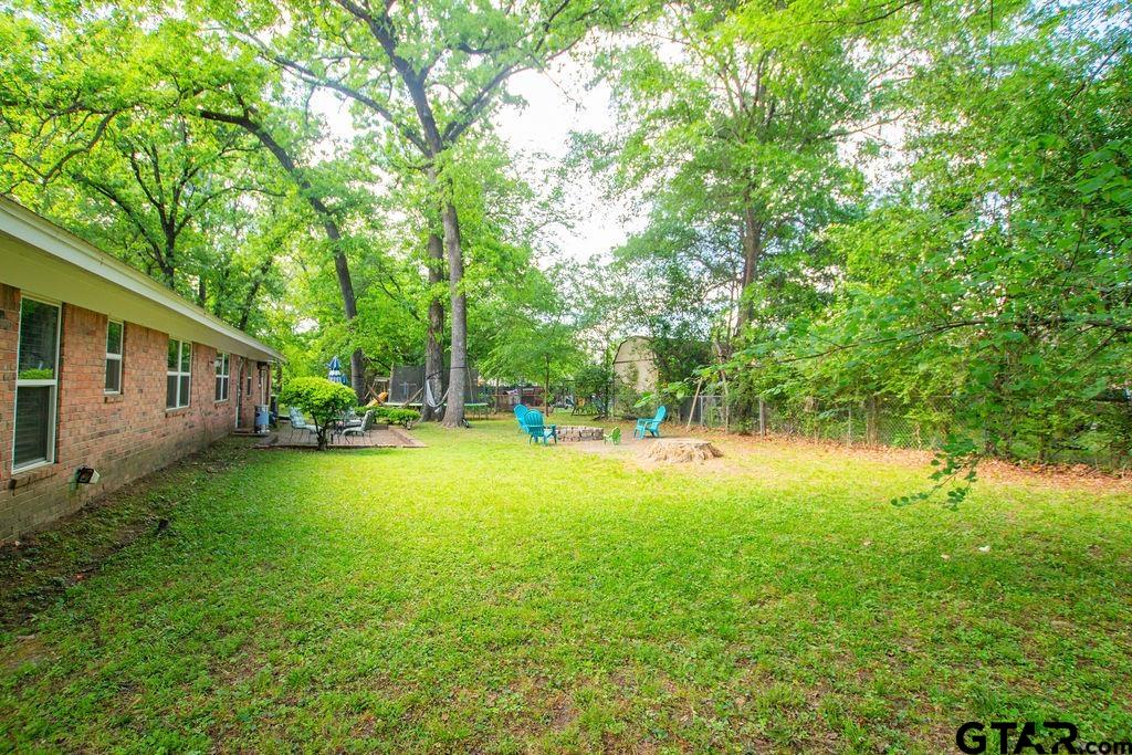 2110 Inwood Circle Tyler, TX 75701 - Photo 43 of 44 a backyard of a house with table and chairs