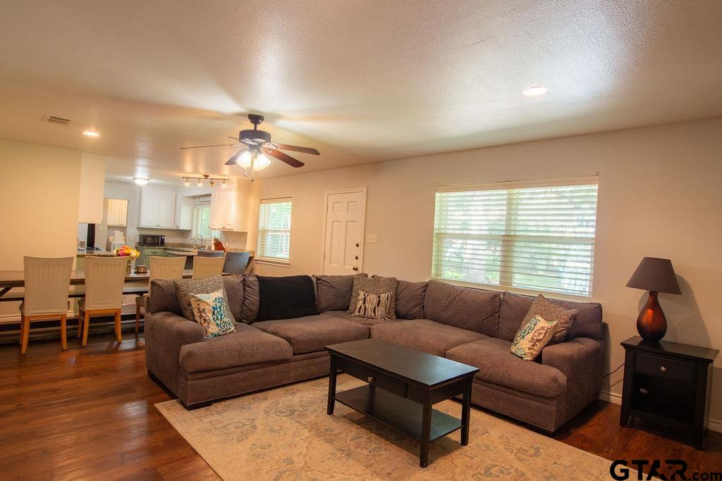 2110 Inwood Circle Tyler, TX 75701 - Photo 5 of 44 a living room with furniture a ceiling fan and a window