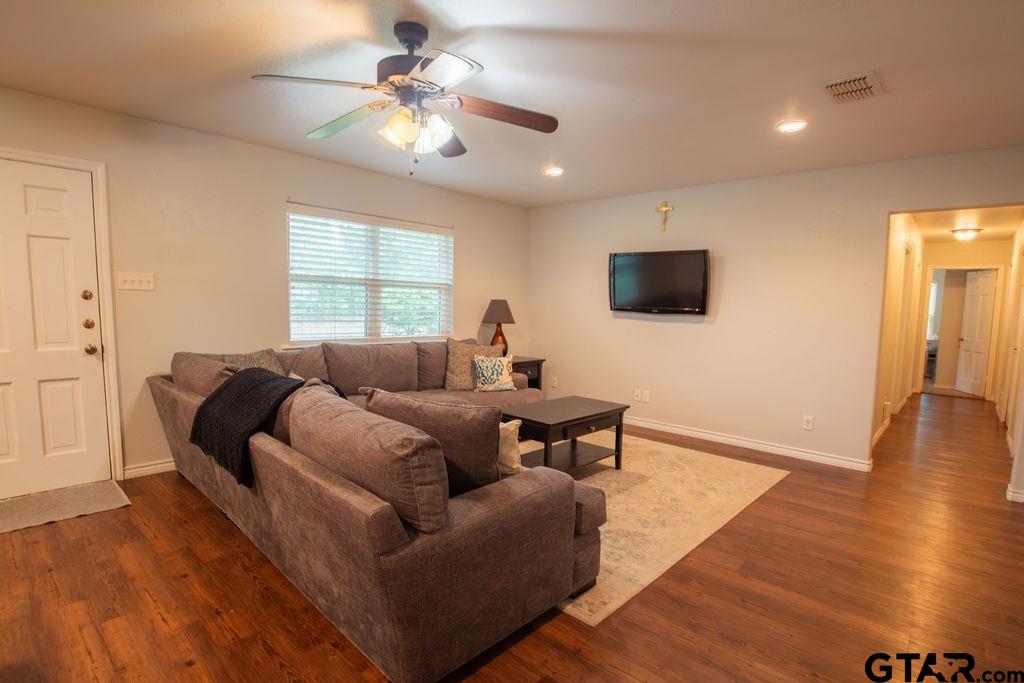 2110 Inwood Circle Tyler, TX 75701 - Photo 6 of 44 a living room with furniture a ceiling fan and a window