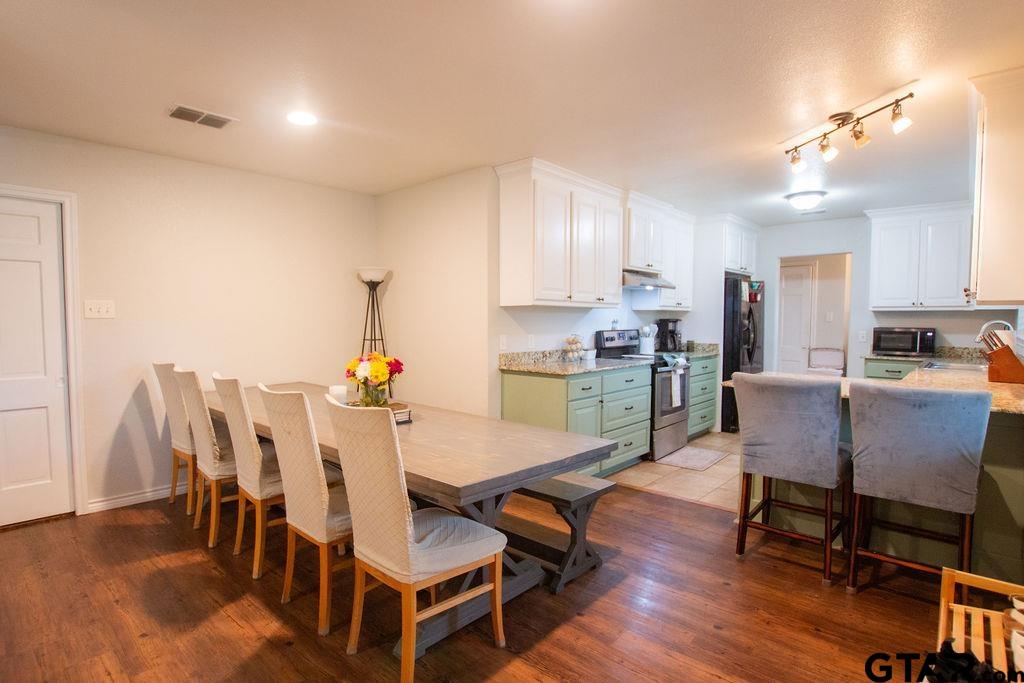 2110 Inwood Circle Tyler, TX 75701 - Photo 9 of 44 a dining room with furniture and wooden floor