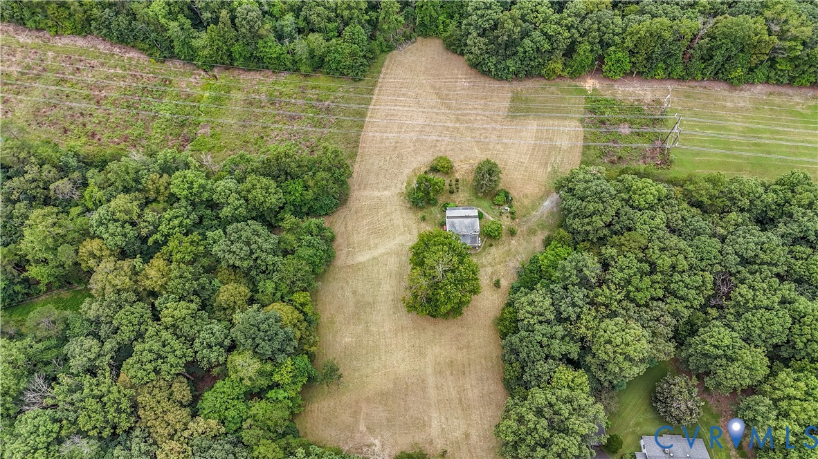 1497 Sutlers Road Charlottesville, VA 22902 - Photo 3 of 20 a view of a lake with a yard and large trees