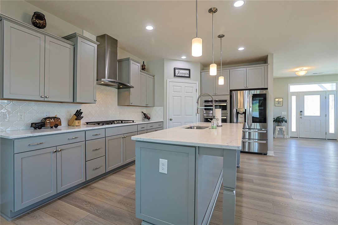 5013 Arena Court Hamilton, OH 45011 - Photo 14 of 41 This bright kitchen features sleek gray cabinetry and a spacious island, perfect for culinary endeavors.