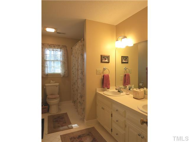 2613 Bembridge Drive Raleigh, NC 27613 - Photo 21 of 25 View of the lg hall Bath w/dbl sinks, tiled flr & tiled tub/shower surround. Bathroom