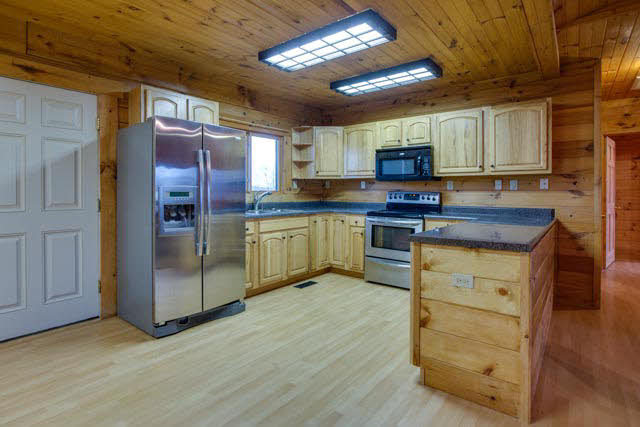 6009 Spring Hill Road Bridgewater, VA 22812 - Photo 3 of 25 a kitchen with stainless steel appliances granite countertop a stove top oven a sink dishwasher and a refrigerator with wooden floor