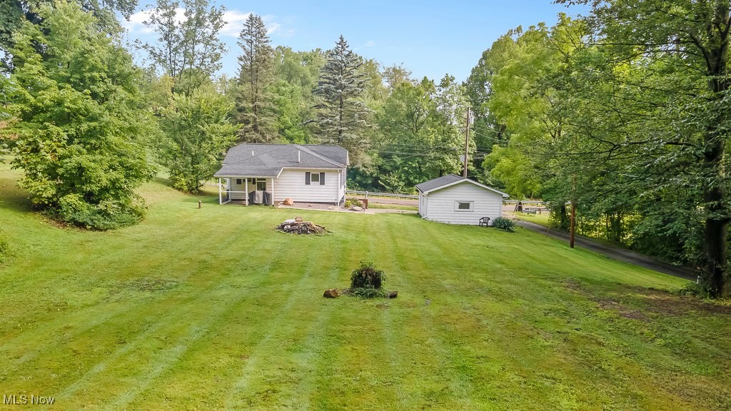 282 Johnson Road Wadsworth, OH 44281 - Photo 48 of 50 View of yard with an outdoor fire pit and a storage shed
