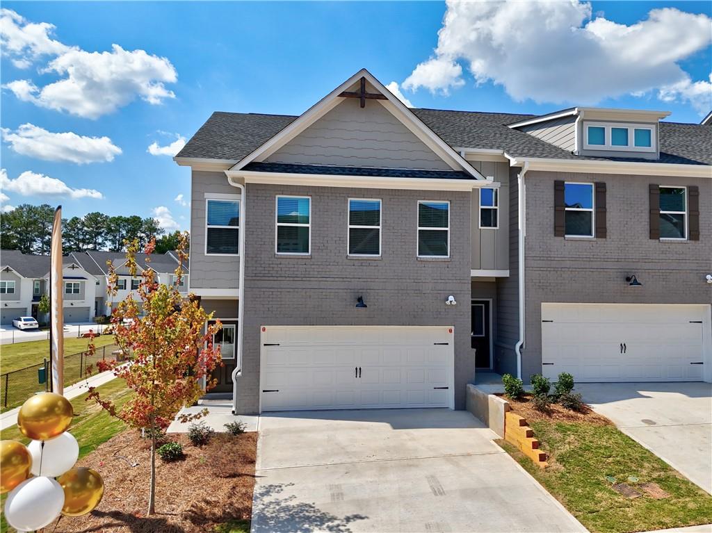 1292 Fern Rdg Lane, Unit 80 Norcross, GA 30093 - Photo 1 of 1 a front view of a house with a yard