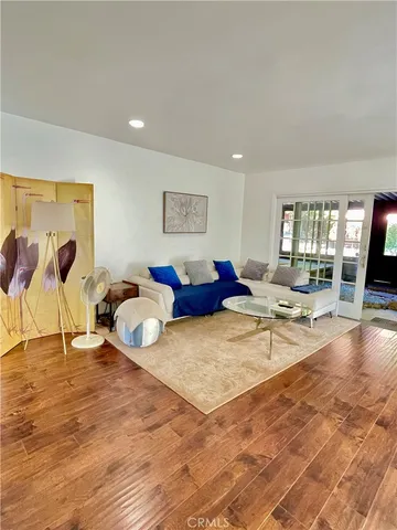 a living room with lots of furniture and wooden floor