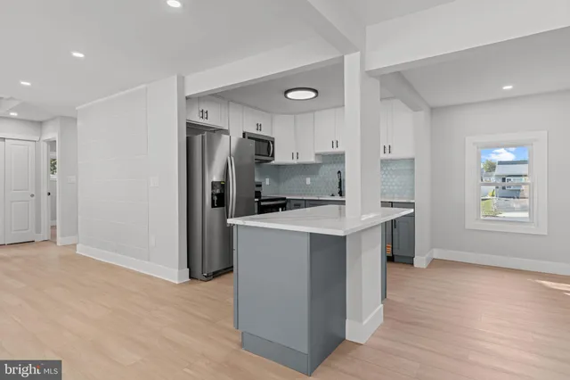 a kitchen with stainless steel appliances granite countertop a refrigerator sink and stove