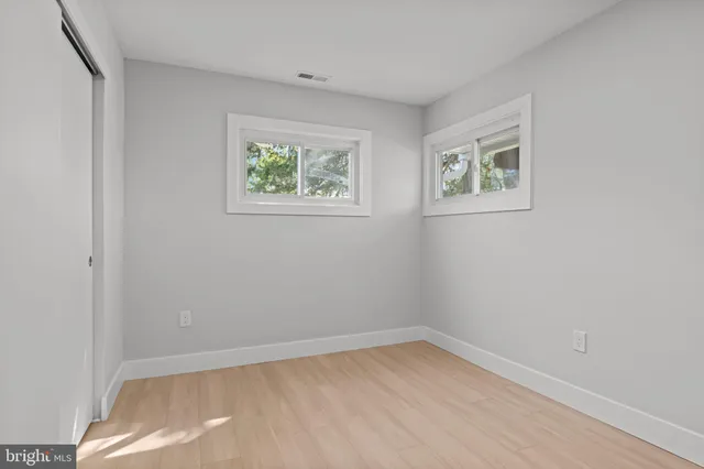 a view of hallway with wooden floor