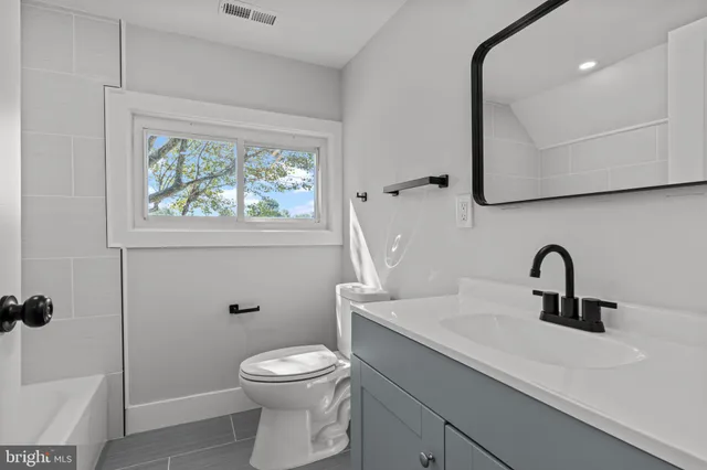 a view of room with window and wooden floor