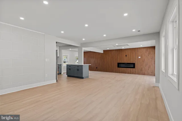 a view of an empty room with window and cabinet