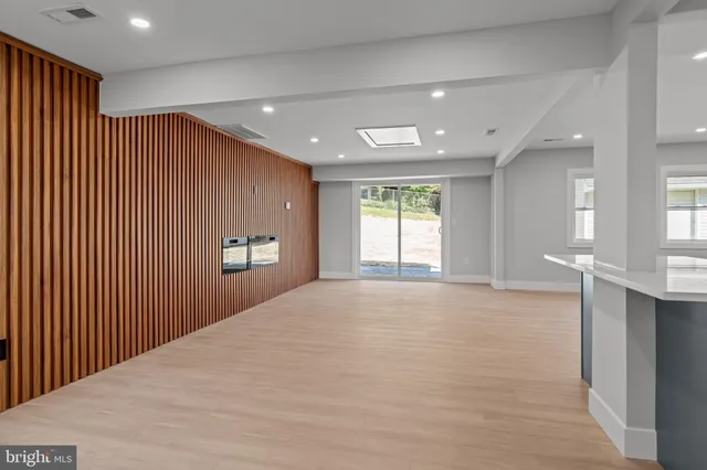 a view of kitchen with refrigerator and window