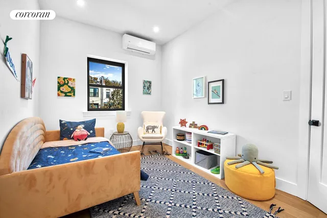 a bedroom with a bed and a painting on the wall