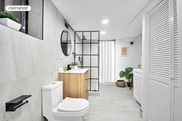 a bedroom with a large bed and potted plant