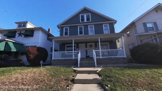 a view of a house with a yard and a large window