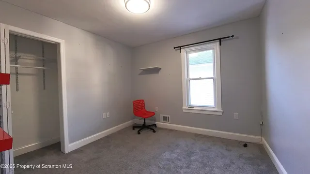 a room with windows and a dresser