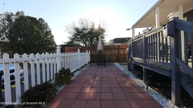 a view of a pathway with a wrought fence