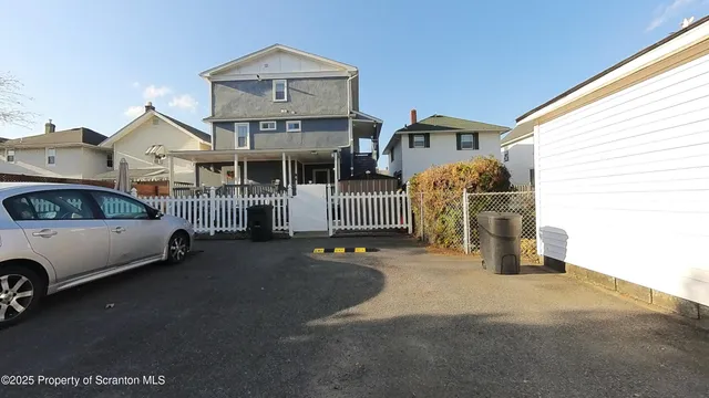 a front view of a house with parking