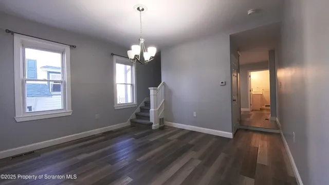 a view of livingroom with hardwood floor and kitchen view