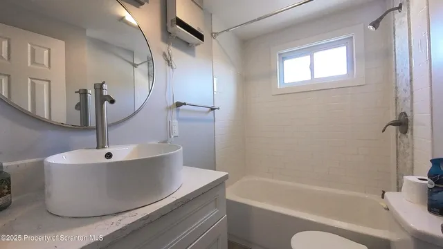 a white bath tub sitting next to a white sink