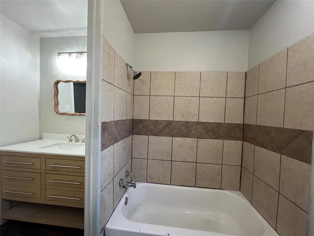 a bathroom with a bathtub and shower