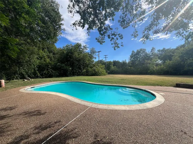 a view of a swimming pool and an outdoor space