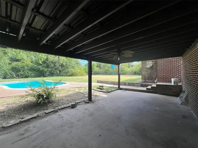 a view of a swimming pool with a yard