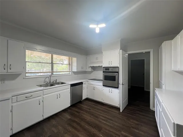 a kitchen with a sink and cabinets