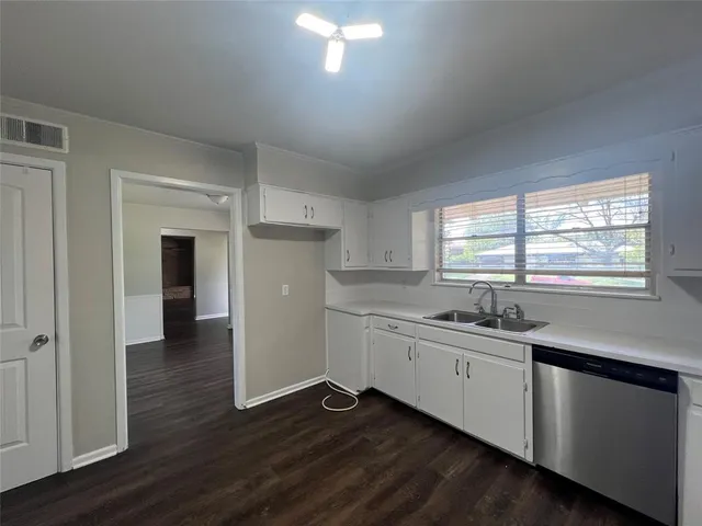 a kitchen with sink and cabinets