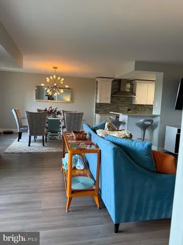 a living room with furniture a dining table and a fireplace