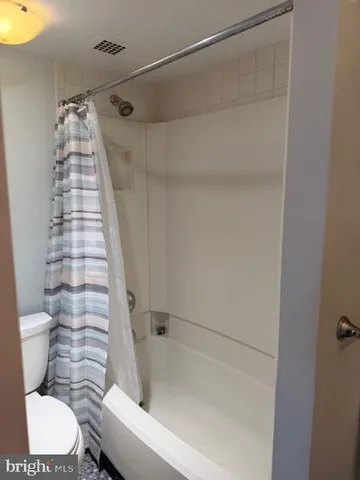 a bathroom with a toilet and shower