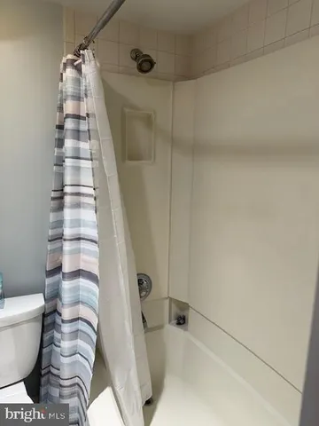 a bathroom with a bathtub and shower