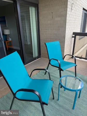 a view of a room with furniture and wooden floor
