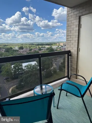 a view of a balcony with chair and wooden floor
