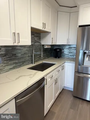 a kitchen with a sink and a refrigerator