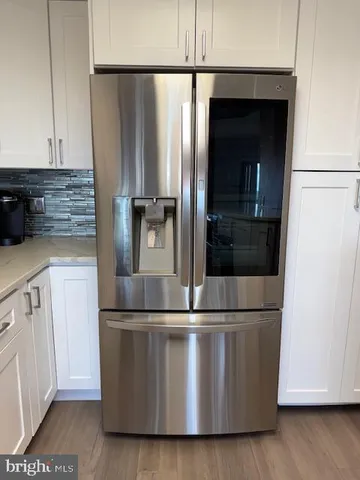 a close view of a refrigerator a oven and cabinets