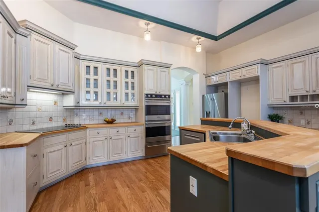 a kitchen with stainless steel appliances granite countertop a sink and cabinets