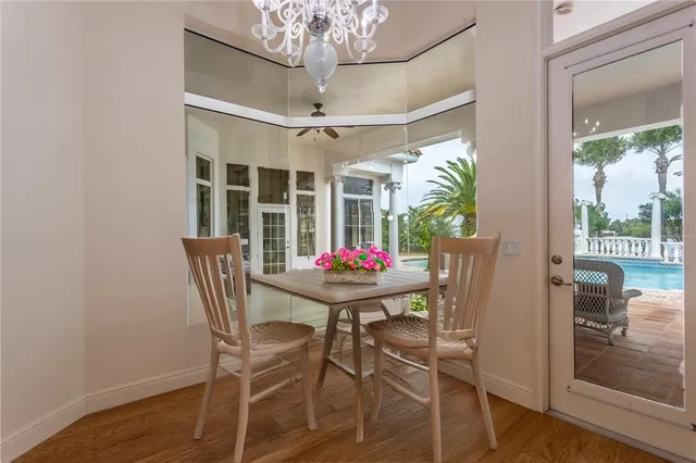 a view of a dining room with furniture wooden floor and chandelier