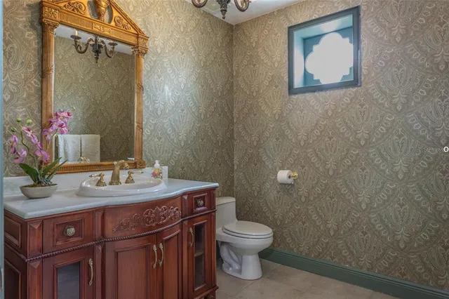 a bathroom with a sink a toilet and mirror