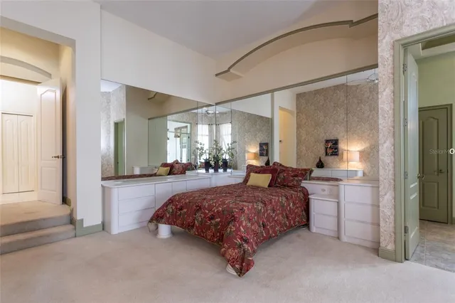 a spacious bedroom with a bed and a dresser