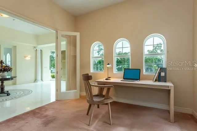 a view of a dining room with furniture and a large window