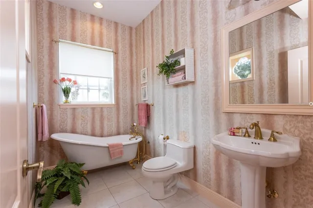 a bathroom with a sink toilet and window