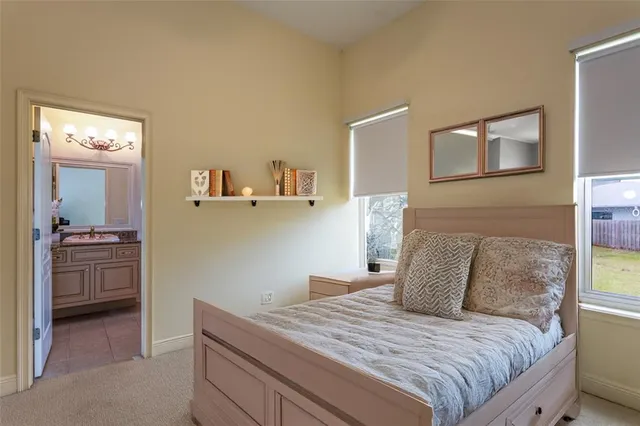 a bedroom with a bed and a view of kitchen