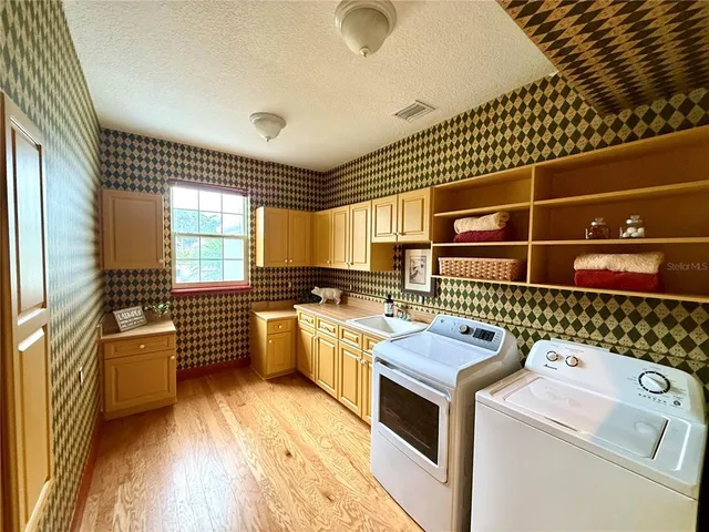 a kitchen that has a sink and a stove in it