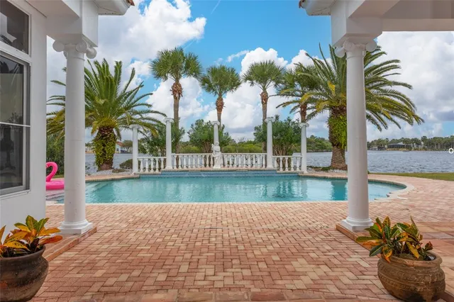a view of swimming pool with a table and chairs