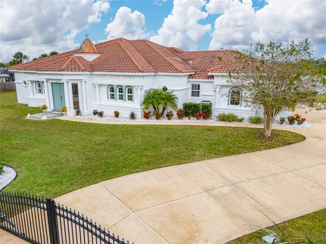 a front view of a house with a garden and yard