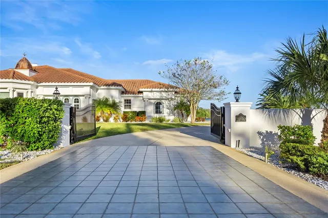 a view of a building with a yard and potted plants