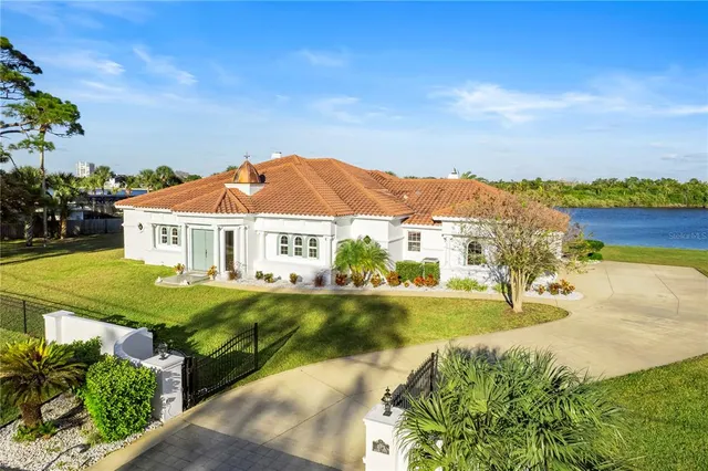 a view of a house with a yard and sitting area