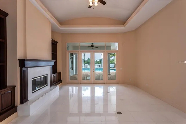 an empty room with fireplace and windows