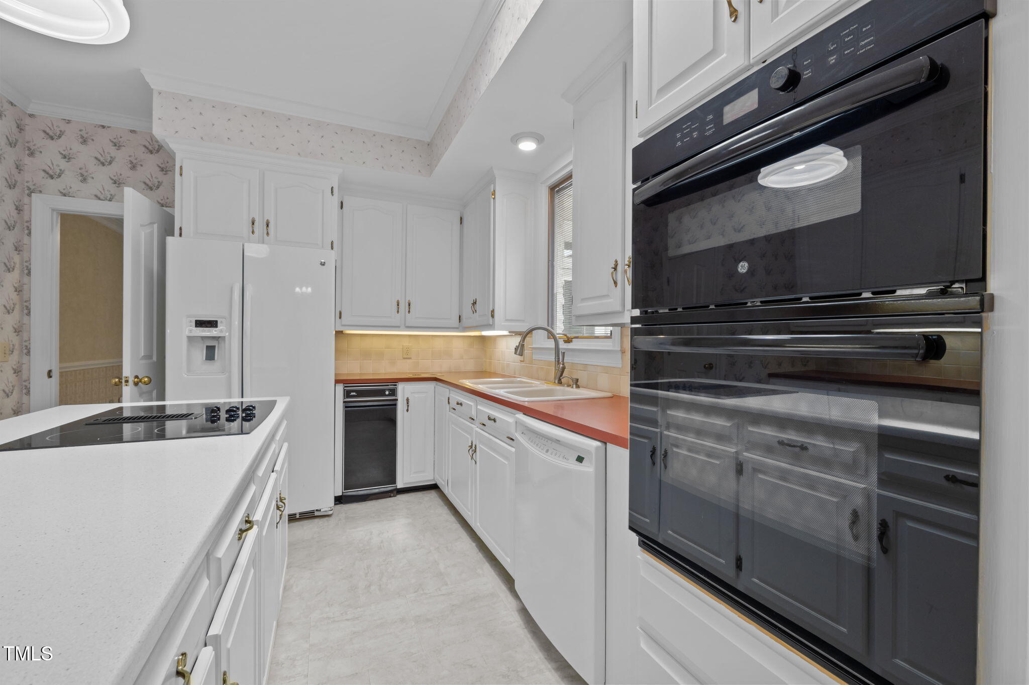 74 Alleghany Drive Roxboro, NC 27573 - Photo 14 of 62 a kitchen with a sink stove and cabinets